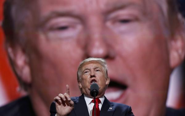 Donald Trump, con su imagen de fondo proyectada para todo el público (AP)