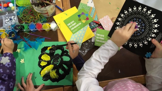 Arts and crafts during Mitzvah Day at the Spandau refugee shelter. The card reads "one good deed leads to the next." November 13, 2016. (Courtesy)