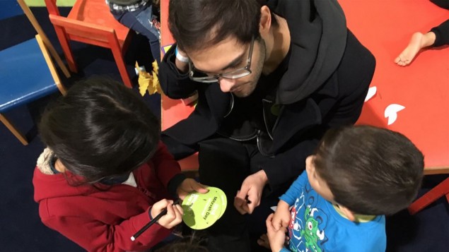 Yacob Yanai, an Israeli living in Berlin, volunteers with refugee children at the Spandau refugee shelter. November 13, 2016. (Courtesy)
