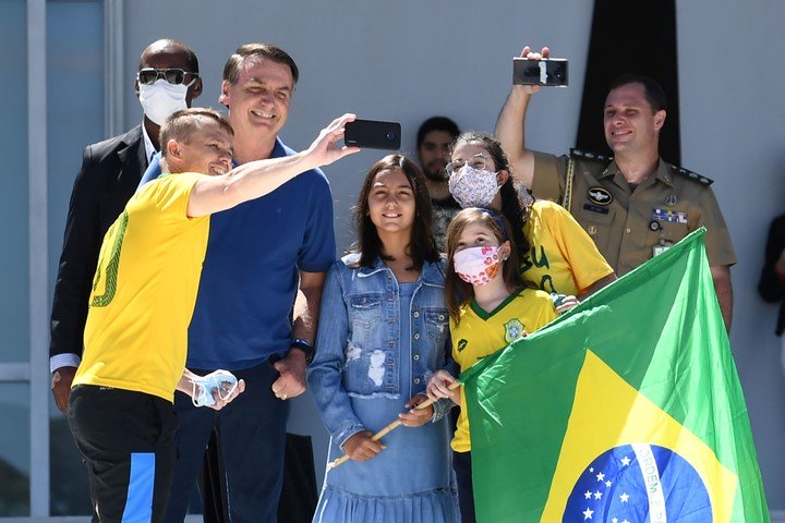 Bolsonaro y su hija se sacan selfies durante las marchas del domingo, en Brasilia. / AFP