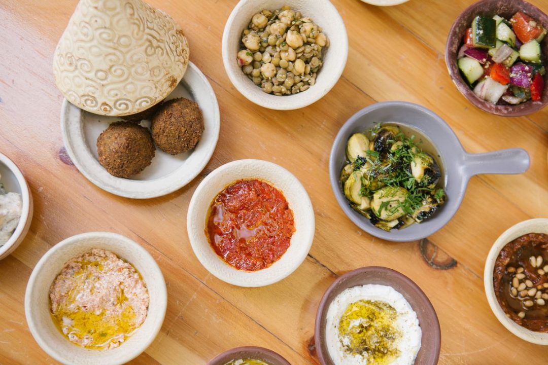 a number of small dishes with various Israeli foods.