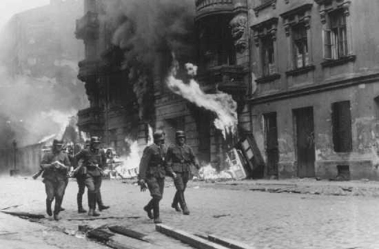 German soldiers burn residential buildings to the ground, one by one, during the Warsaw ghetto uprising. [LCID: 46202]