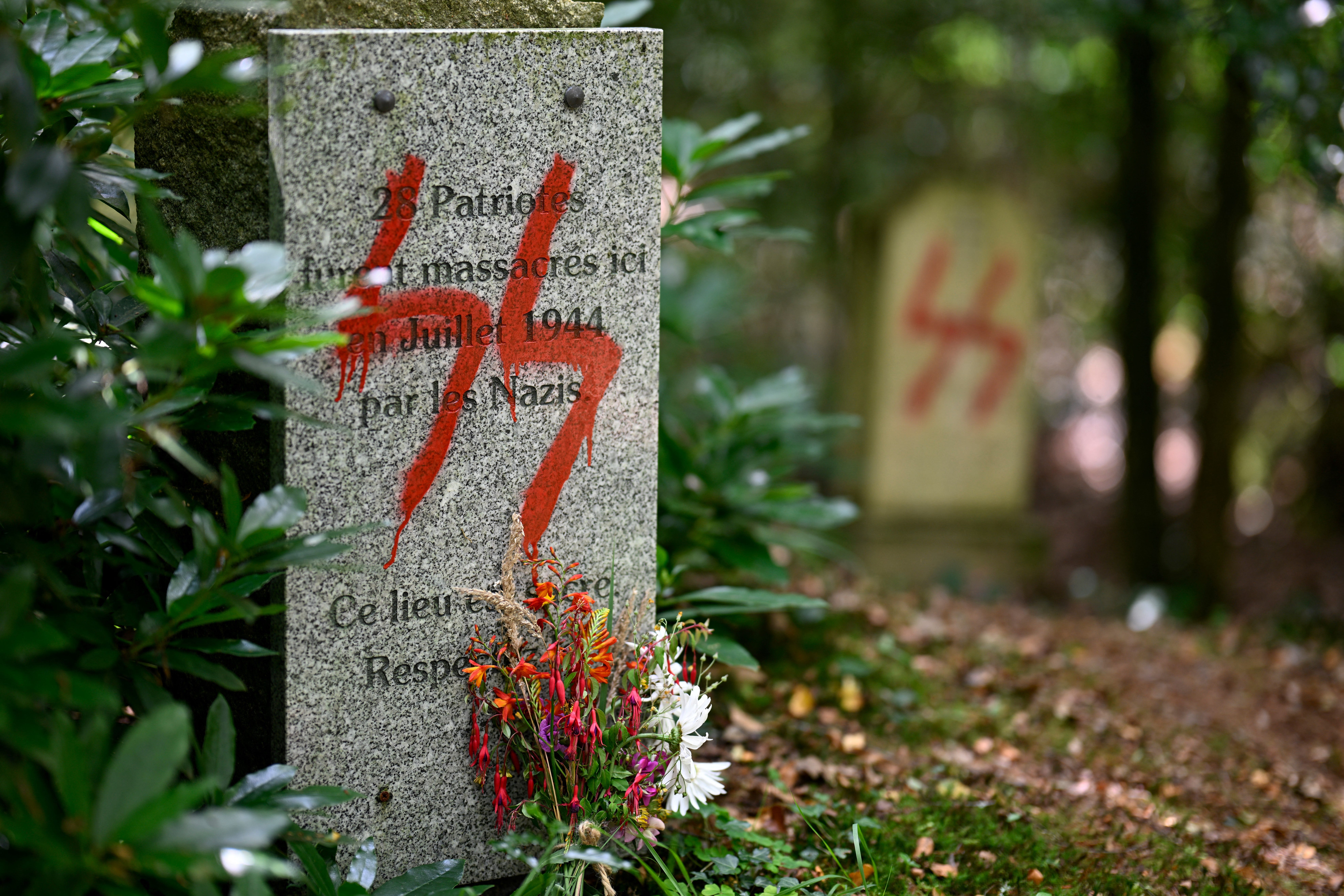 This picture taken on July 17, 2023 shows a graffito of a Nazi SS symbol on a monument in memory of 55 people executed at this site by the Nazis in 1944 during World War II, in Ploeuc-L'Hermitage, some 20km south of Saint-Brieuc, western France.